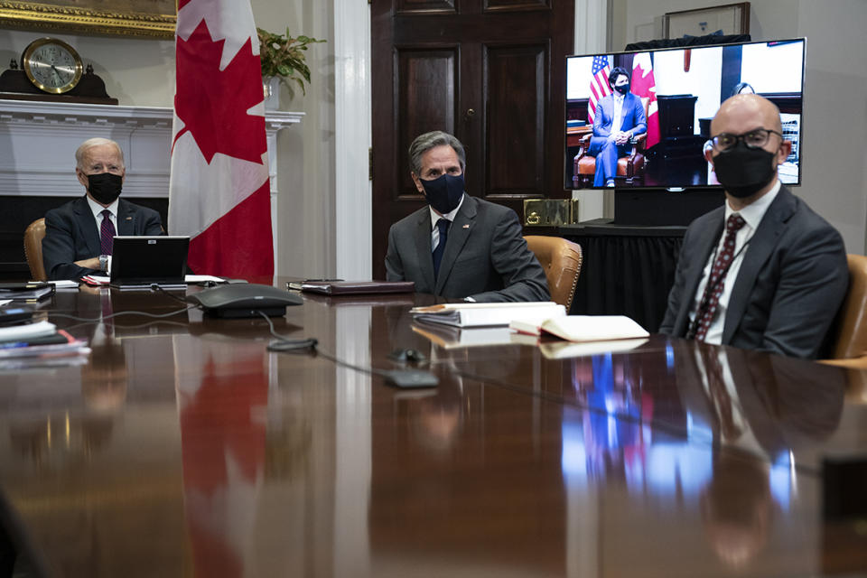 President Joe Biden holds a virtual bilateral meeting with Canadian Prime Minister Justin Trudeau, in the Roosevelt Room of the White House, Tuesday, Feb. 23, 2021, in Washington. From left, Secretary of State Antony Blinken, and and National Security Council senior director for the Western Hemisphere Juan Gonzalez. (AP Photo/Evan Vucci)