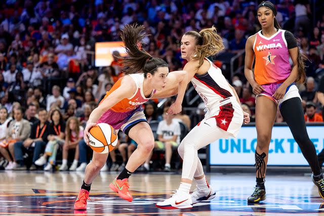 <p>Dylan Goodman/NBAE via Getty</p> Caitlin Clark (L) of Team WNBA dribbles the ball past Sabrina Ionescu (C) of the USA Women's National Team during the 2024 WNBA All Star Game at Footprint Center on July 20, 2024 in Phoenix, Arizona.