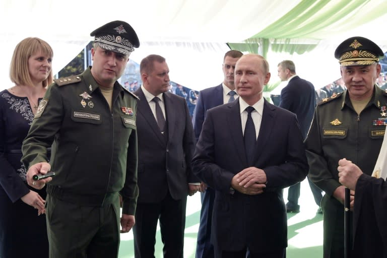 Russia's President Vladimir Putin (C), Russian Defence Minister Sergei Shoigu (R) and Deputy Minister of Defense of the Russian Federation Timur Ivanov (L) visit the military Patriot Park in Kubinka, outside Moscow in 2018 (Alexey NIKOLSKIY)