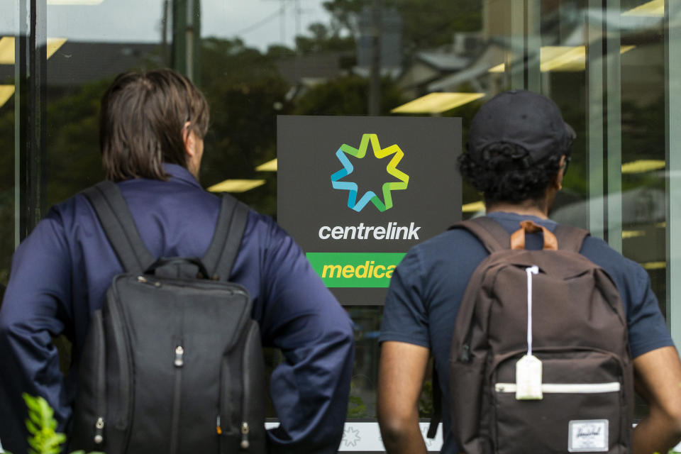 SYDNEY, AUSTRALIA - MARCH 23: People are seen lining up at Centrelink in Bondi Junction on March 23, 2020 in Sydney, Australia. From midday Monday, venues such as bars, clubs, nightclubs, cinemas, gyms and restaurants, along with anywhere people remain static would be closed. Schools remain open but parents have the option to keep children at home if they wish while Victoria is bringing forward school holidays from Tuesday. There are now 1353 confirmed cases of COVID-19 in Australia and the death toll now stands at seven. (Photo by Jenny Evans/Getty Images)