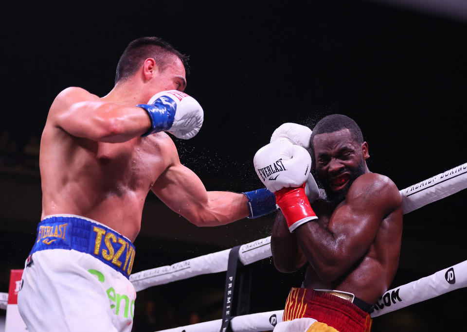 Pictured left, Australia's Tim Tszyu hits American Terrell Gausha in their super welterweight fight in Minneapolis. 