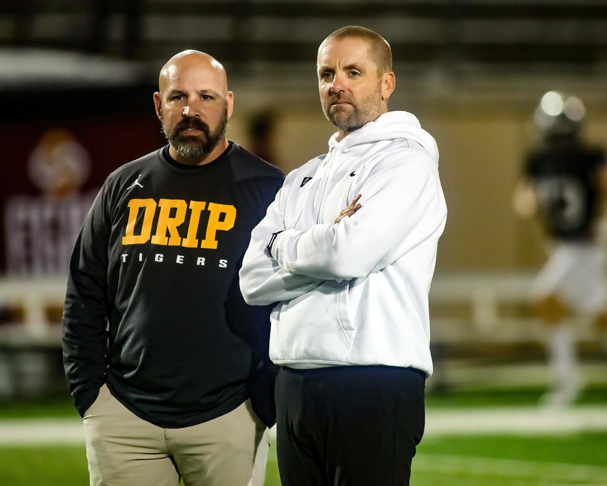 Vandegrift coach Drew Sanders, right, standing with Dripping Springs' Galen Zimmerman before a game, has guided his team to 106 victories in the last 10 years. He's looking to fill the shoes of six key seniors who are moving on to play in college.