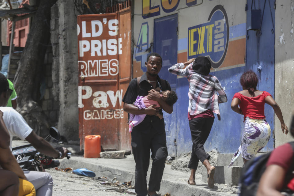 Residents flee their homes to escape clashes between armed gangs in the Carrefour-Feuilles district of Port-au-Prince, Haiti, Tuesday, Aug. 15, 2023. (AP Photo/Odelyn Joseph)