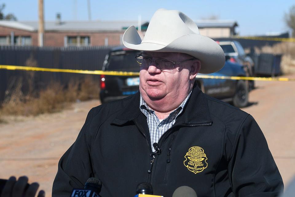 Oklahoma Bureau of Investigation Capt. Stan Florence gives a press briefing Monday, Nov. 21, 2022, outside a residence near Lacey, Oklahoma, in Kingfisher County, which was the scene of a quadruple homicide. State police in Oklahoma say that four people killed at a marijuana farm were "executed," and that they were Chinese citizens.