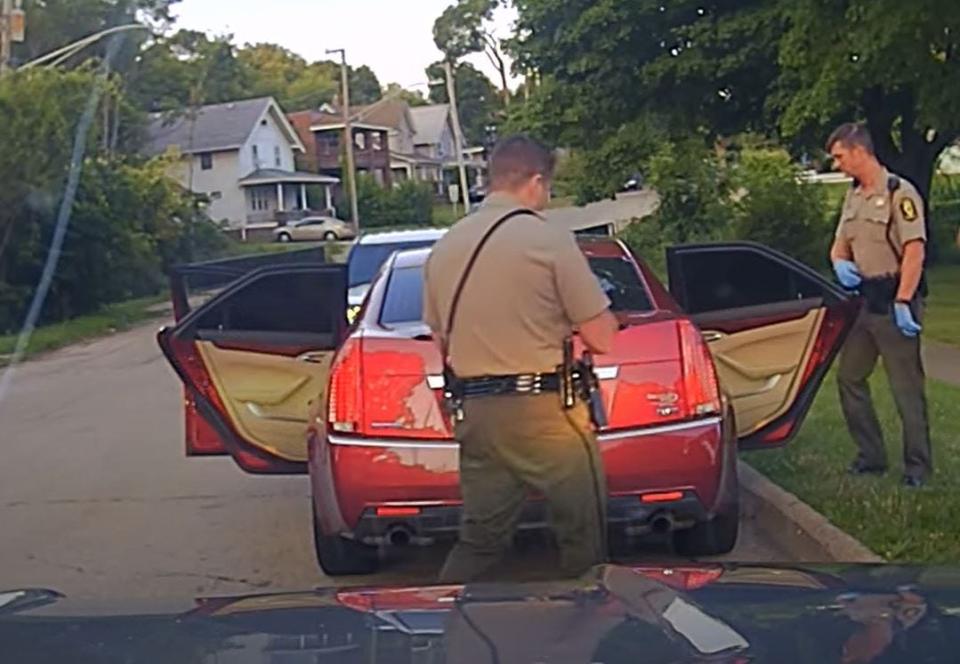 A screenshot from dash camera video show Illinois State Police searching the car of Lamar Bell during a traffic stop Sunday, July 16, 2023, in Rockford.