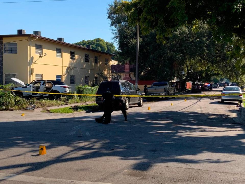 Miami police believe the white Range Rover, in the apartment building yard to the left, smashed into the red Nissan, the rear of which can be seen in the shade on the left side of Northwest 11th Avenue.