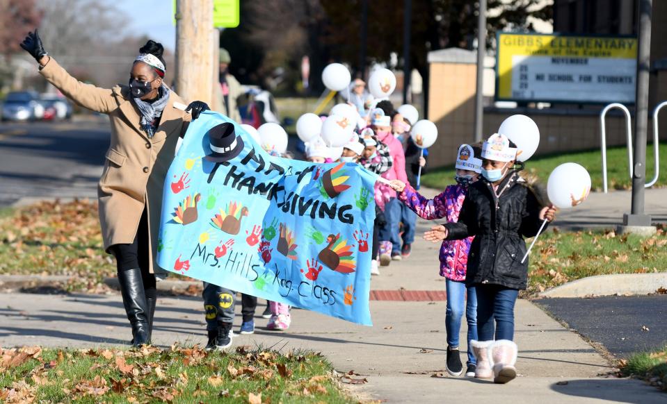 Tajuana Hill's kindergarten class at Gibbs Elementary waves to the crowd Tuesday during the school's Thanksgiving parade.