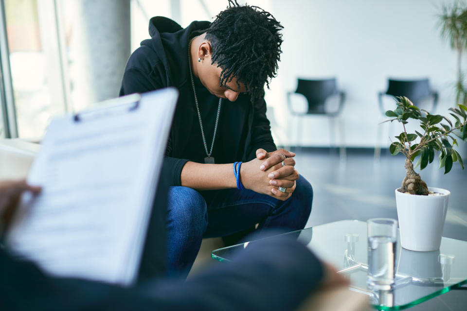 Teenager looking down while having a therapy session