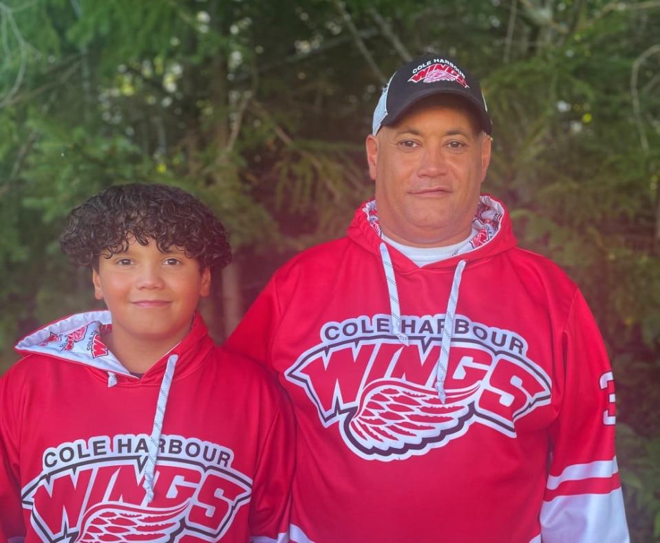 Austin Hurdis, left, plays with the Cole Harbour Wings and is pictured with his father, Brian.