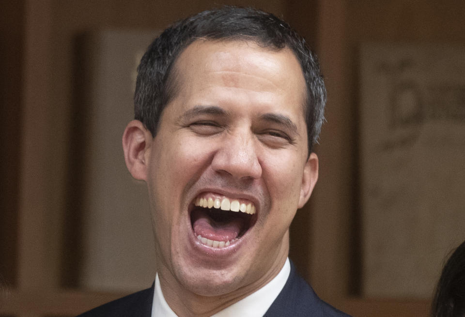 The leader of Venezuela's political opposition Juan Guaido laughs after a meeting at the Madrid regional government building during a visit to Madrid, Spain, Saturday, Jan. 25, 2020. Juan Guaido, the man who one year ago launched a bid to oust Venezuelan President Nicolas Maduro, arrived Saturday in Spain, where a thriving community of Venezuelans and a storm among Spanish political parties awaited him.(AP Photo/Paul White)