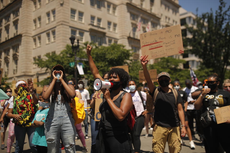 Demonstrators protest Sunday, June 7, 2020, near the White House in Washington, over the death of George Floyd, a black man who was in police custody in Minneapolis. Floyd died after being restrained by Minneapolis police officers on Memorial Day. (AP Photo/Maya Alleruzzo)