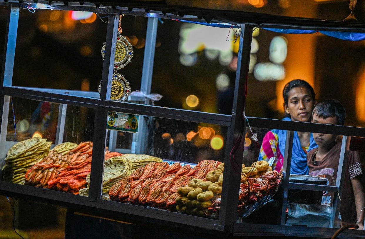 Sri Lanka is among the countries facing the risk of debt distress. <a href="https://www.gettyimages.co.uk/detail/news-photo/street-vendor-sells-prawns-and-sea-food-at-her-kiosk-at-the-news-photo/1248858886?adppopup=true" rel="nofollow noopener" target="_blank" data-ylk="slk:Ishara S. Kodikara/AFP via Getty Images;elm:context_link;itc:0;sec:content-canvas" class="link ">Ishara S. Kodikara/AFP via Getty Images</a>