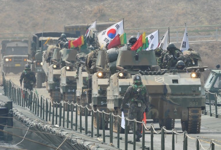 South Korean K-200 armoured vehicles move over a temporary bridge during a military drill in Hwacheon, near the border with North Korea, on April 1, 2013. UN chief Ban Ki-moon warned Tuesday that the Korean peninsula crisis could spiral out of control, after North Korea announced it would restart a nuclear reactor to feed its atomic weapons programme