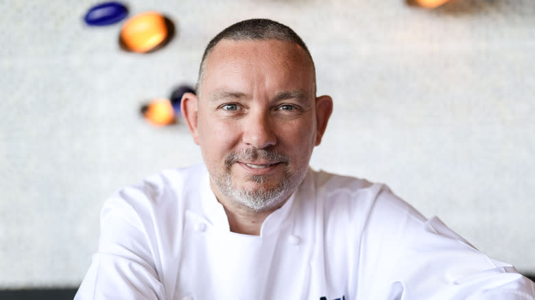 Albert Adrià smiles in a chef coat