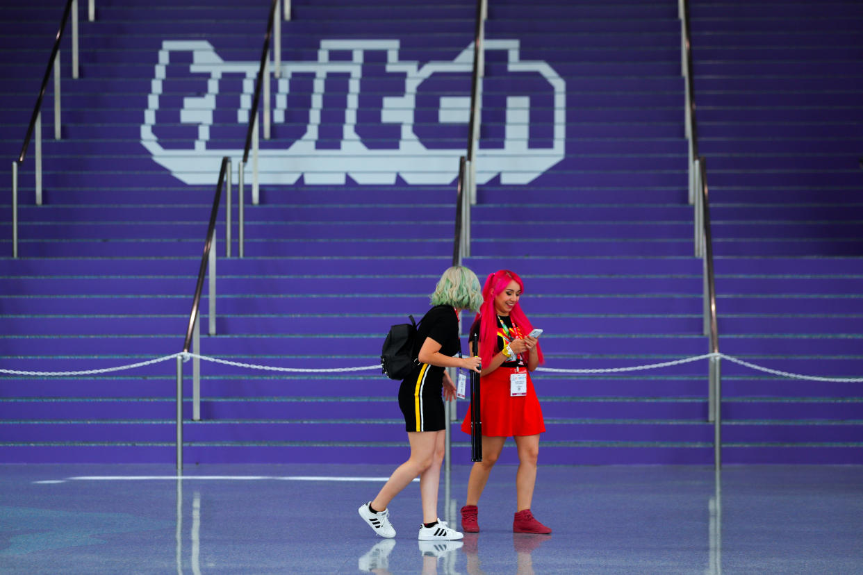Attendees walk past a Twitch logo painted on stairs during opening day of E3, the annual video games expo revealing the latest in gaming software and hardware in Los Angeles, California, U.S., June 11, 2019.  REUTERS/Mike Blake