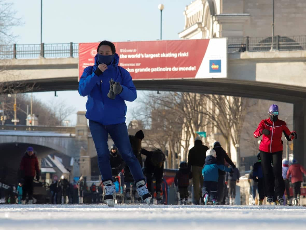 People skate on the Rideau Canal Skateway on Jan. 14, its opening day of the season. The National Capital Commission is partnering with Carleton University to study ways to potentially open the skateway earlier in years to come. (Patrick Doyle/Reuters - image credit)