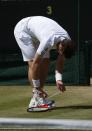 Great Britain's Andy Murray ties his shoe laces in his Men's Final against Serbia's Novak Djokovic during day thirteen of the Wimbledon Championships at The All England Lawn Tennis and Croquet Club, Wimbledon.