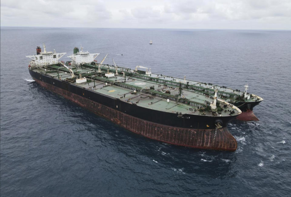 In this photo released by Indonesian Maritime Security Agency (BAKAMLA), Panamanian-flagged MT Frea, left, and Iranian-flagged MT Horse tankers are seen anchored together in Pontianak waters off Borneo island, Indonesia, Sunday, Jan. 24, 2021. Indonesian authorities said that they seized the two vessels suspected of carrying out the illegal transfer of oil in their country's waters. (Indonesian Maritime Security Agency via AP)