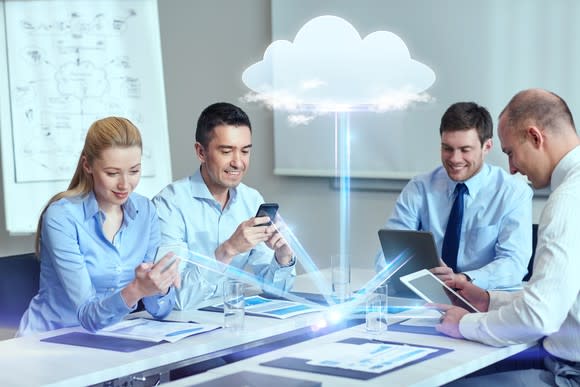 A group of workers access cloud-based applications.