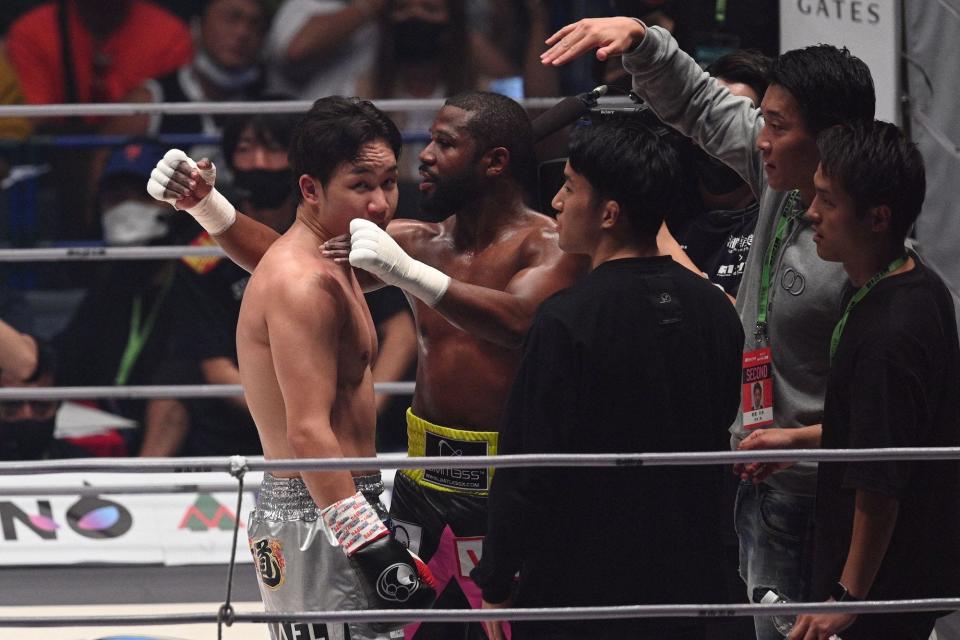 Floyd Mayweather embraces Mikuru Asakura after beating him in round two.