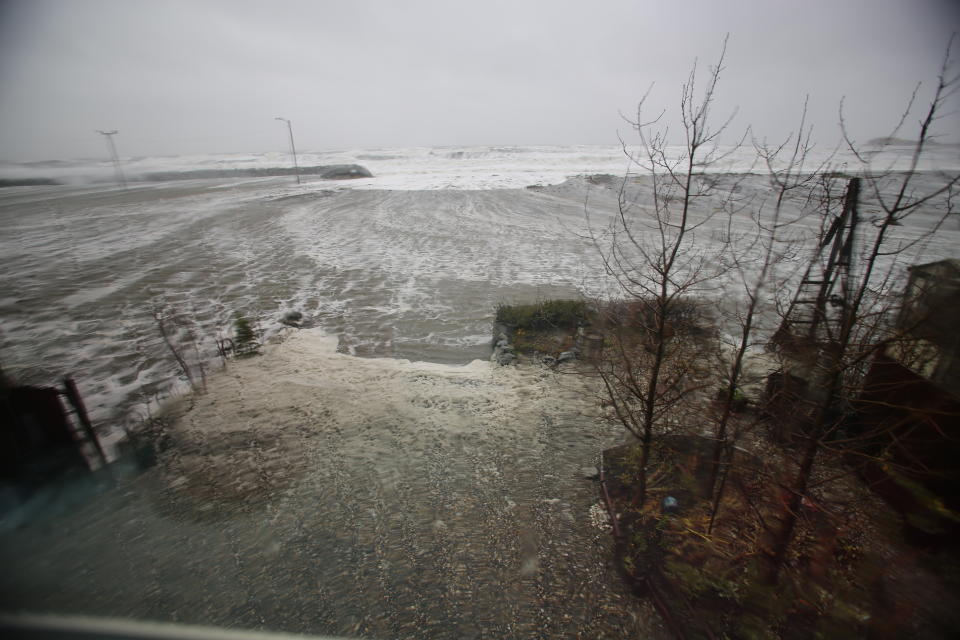 Water from the Bering Sea, pushed by high winds, rushes into a home's backyard in Nome, Alaska, on Saturday, Sept. 17, 2022. Much of Alaska's western coast could see flooding and high winds as the remnants of Typhoon Merbok moved into the Bering Sea region. The National Weather Service says some locations could experience the worst coastal flooding in 50 years. (AP Photo/Peggy Fagerstrom)