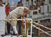 Hindu nationalist Narendra Modi, the prime ministerial candidate for India's main opposition Bharatiya Janata Party (BJP), greets his supporters after addressing a public meeting in Vadodara, in the western Indian state of Gujarat, May 16, 2014. REUTERS/Amit Dave