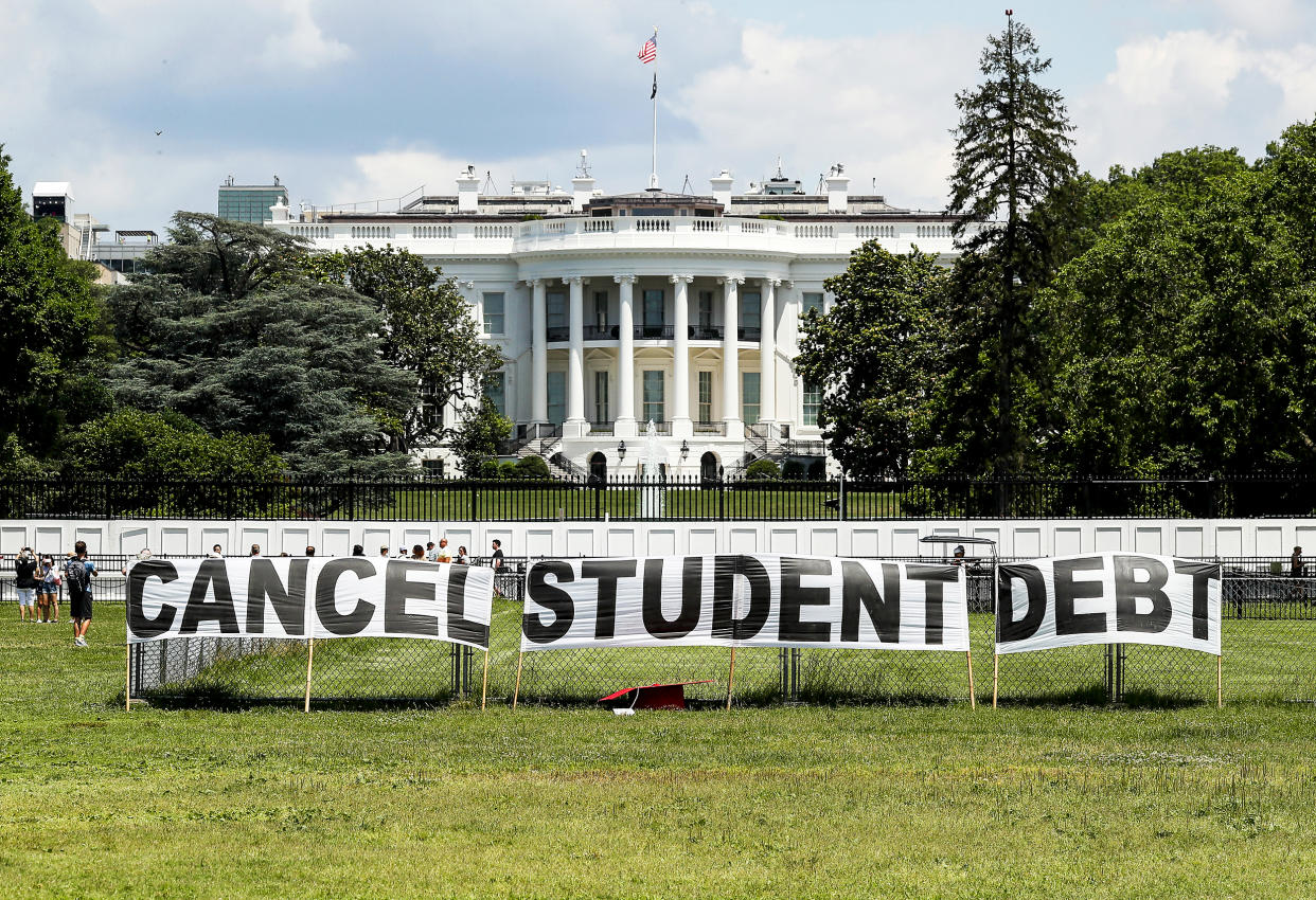 Advocates set up a sign on the Ellipse in front of the White House to call on President Joe Biden to sign an executive order to cancel student debt on June 15, 2021. (Paul Morigi / Getty Images for We The 45 Million)