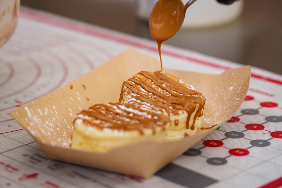 Biscoff butter is drizzled over Japanese souffle pancakes at the Fluffy Cakes kiosk inside the Chandler mall on June 15, 2023.