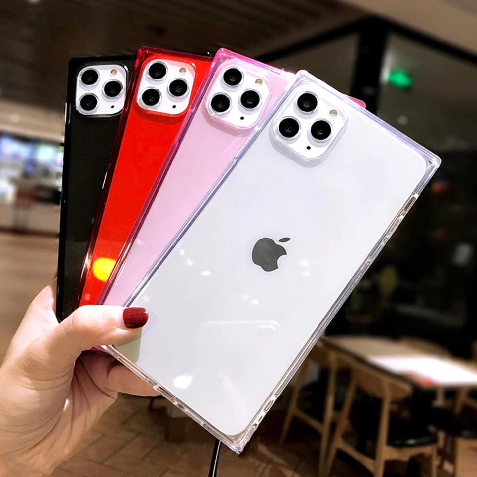 Clear iPhone cases in hand.