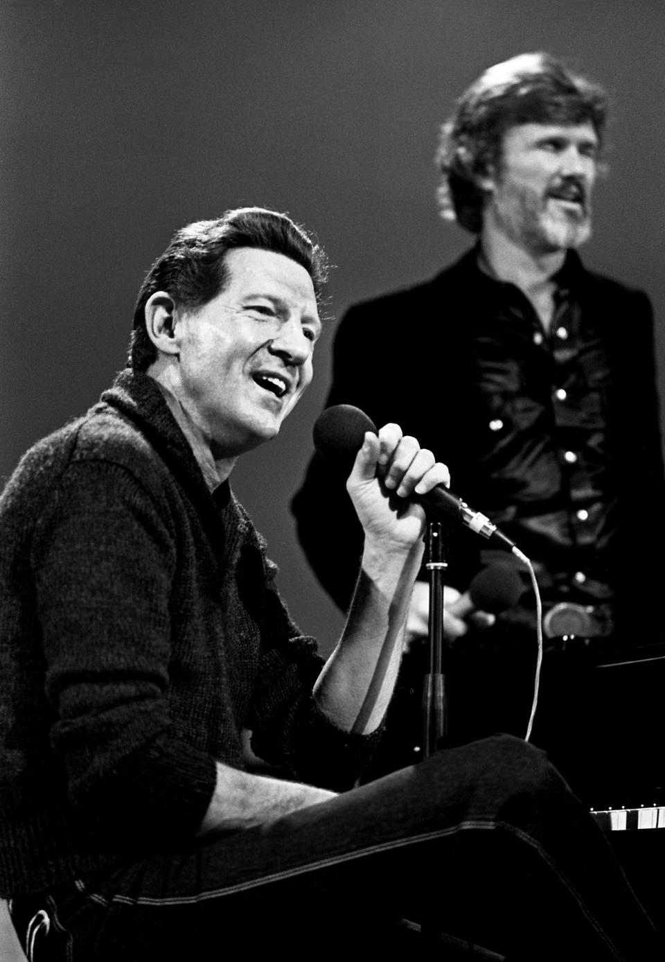 Jerry Lee Lewis, front, with Kris Kristofferson, talks with the audience before taping a special for HBO at the Tennessee Performing Arts Center in Nashville Jan. 19, 1982. The special will be air on Home Box Office in April.