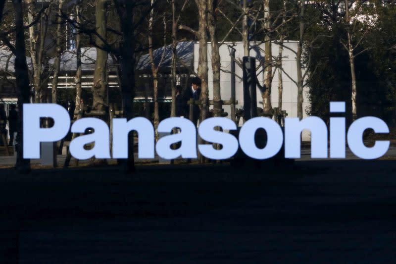 FILE PHOTO: A pedestrian is reflected in a sign at Panasonic Center in Tokyo