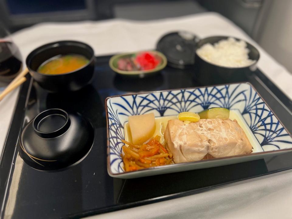A tray containing the author's meal, including salmon, miso soup, and rice.