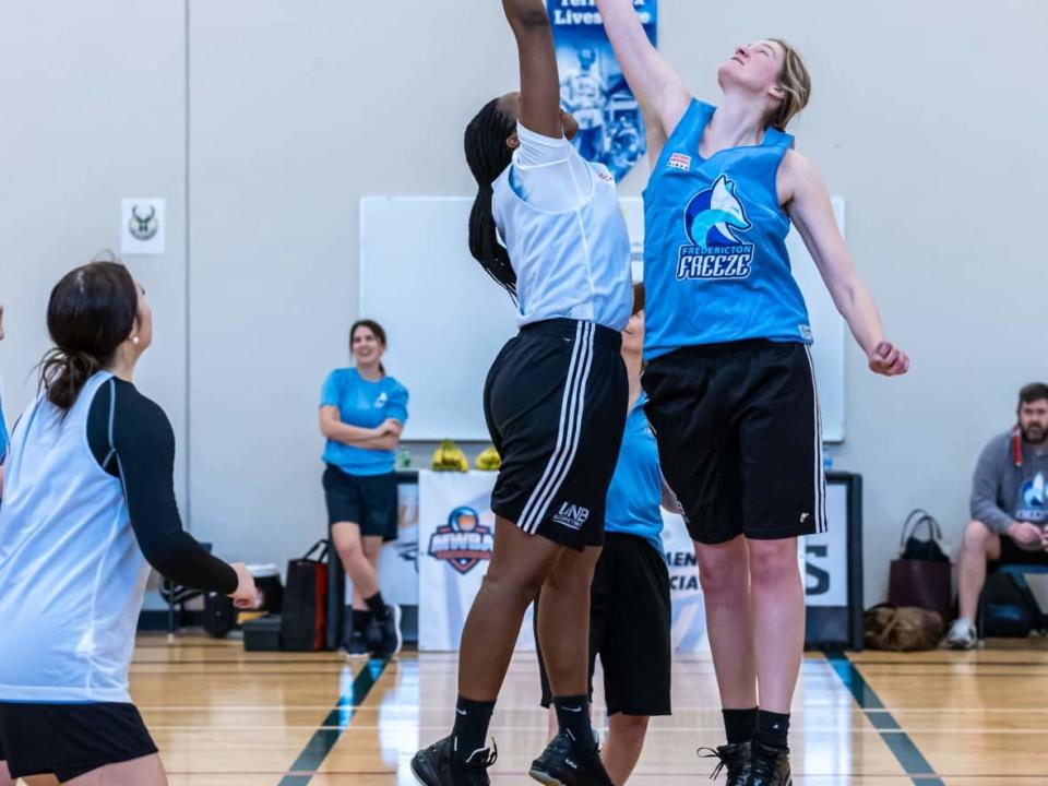 Two members of the Fredericton Freeze jump for a tip during training camp. The Freeze are one of six teams set to play in the inaugural Maritime Women's Basketball Association season, which begins on Saturday. (Fran Harris Photos/Submitted by Brad Janes - image credit)