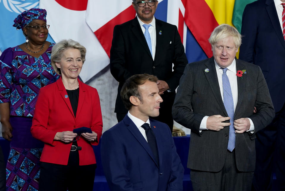 From left, World Trade Organization Director-General Ngozi Okonjo-Iweala, European Commission President Ursula von der Leyen, French President Emmanuel Macron, World Health Organisation Tedros Adhanom Ghebreyesus, British Prime Minister Boris Johnson pose during a group photo at the G20 summit in Rome, Saturday, Oct. 30, 2021. The two-day Group of 20 summit is the first in-person gathering of leaders of the world's biggest economies since the COVID-19 pandemic started. (AP Photo/Evan Vucci, Pool)