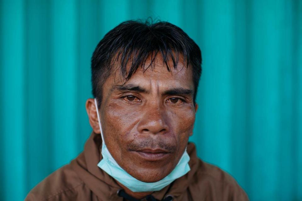 Lewi Kai sat and waited for news of his wife next to the building that collapsed on her as rescue workers rotated in shifts around the clock to recover her body (Paddy Dowling)