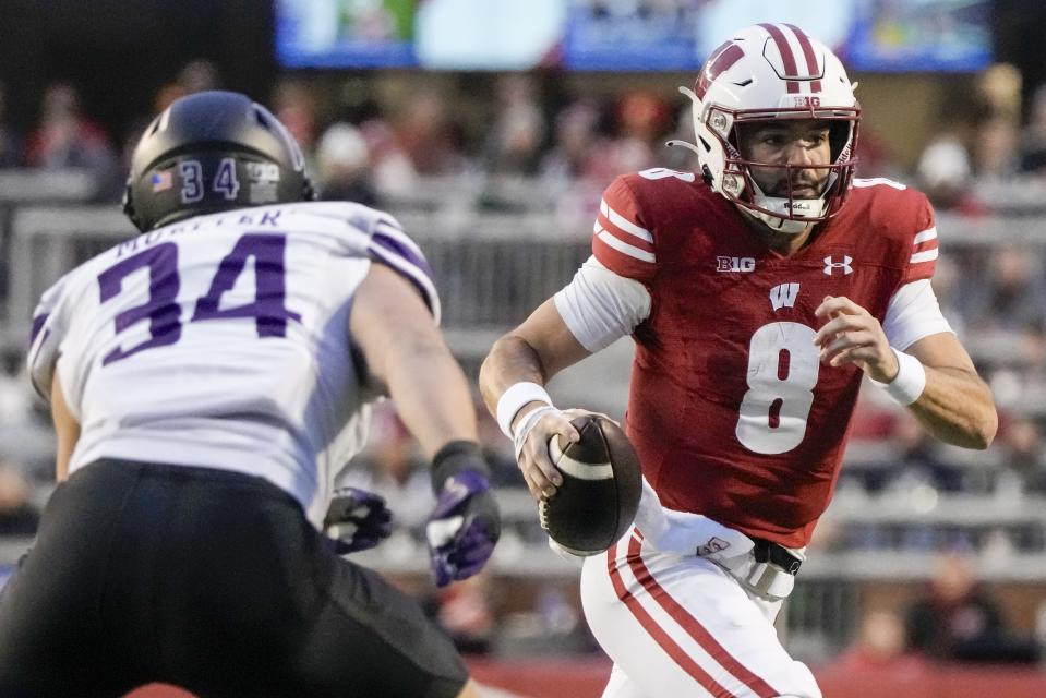 Wisconsin's Tanner Mordecai (8) tries to get past Northwestern's Xander Mueller during the second half of an NCAA college football game Saturday, Nov. 11, 2023, in Madison, Wis. (AP Photo/Morry Gash)