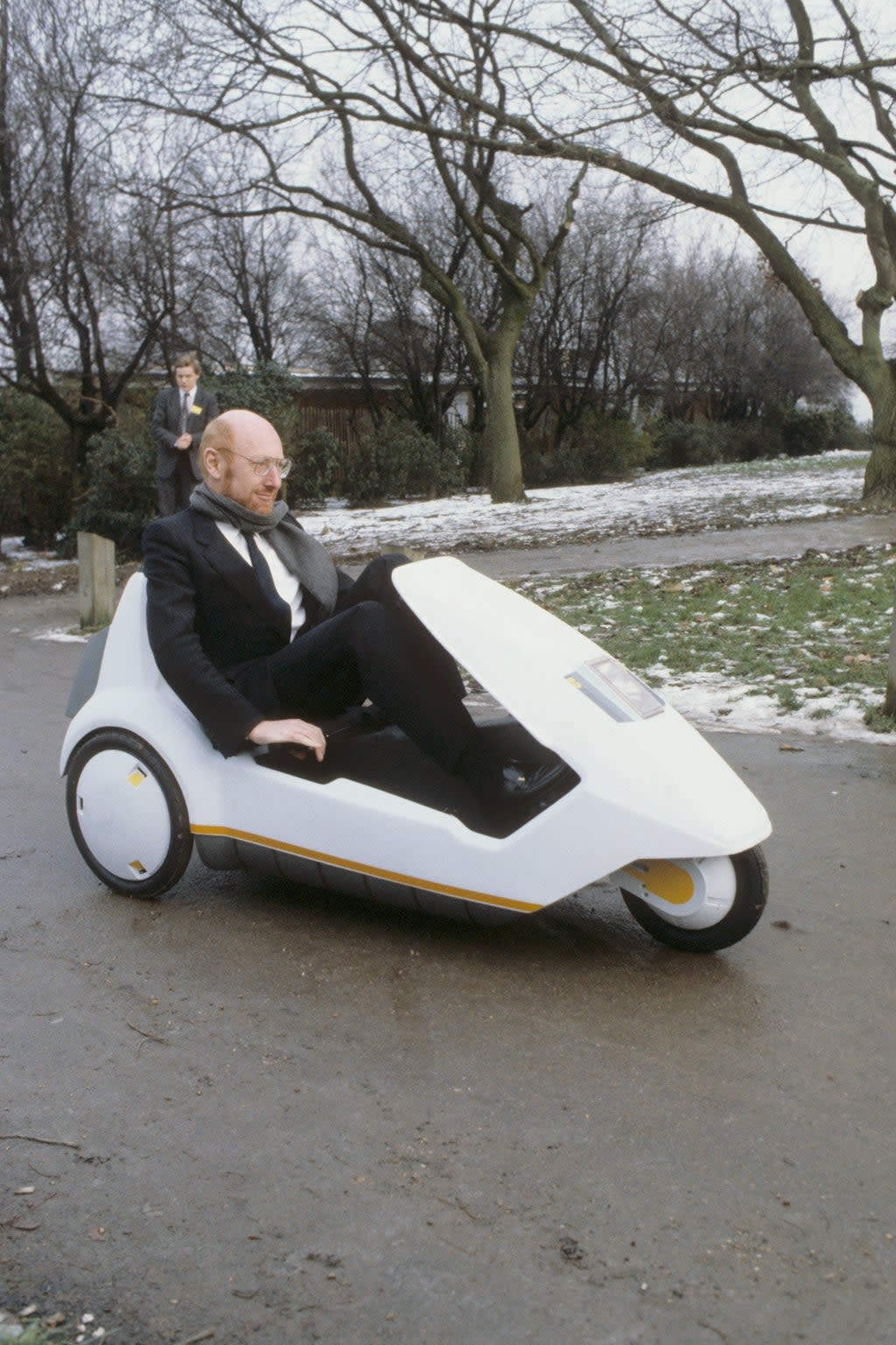 Sir Clive Sinclair demonstrating his C5 electric vehicle (PA) (PA Archive)