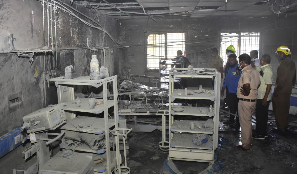 People inspect a hospital's COVID-19 ward that caught fire in Ahmednagar, in the western Indian state of Maharashtra, Saturday, Nov. 6, 2021. Ten patients died in the fire, officials said. Such incidents are not uncommon in India. In May, when the country was battling a devastating surge in coronavirus cases, a fire in a COVID-19 ward in western India killed at least 18 patients. (AP Photo)