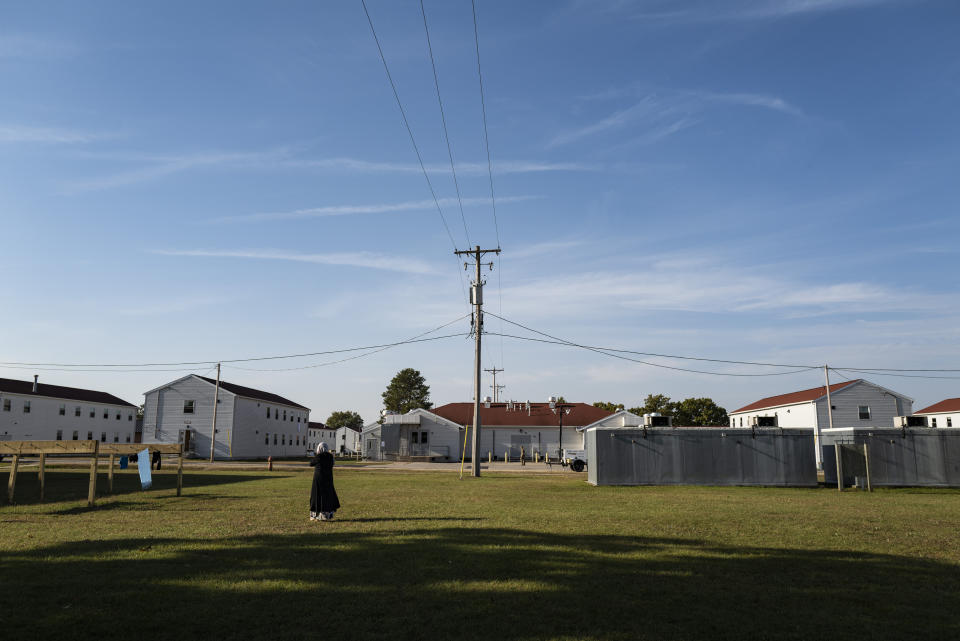 An Afghan refugee walks in the Village, where they are temporarily living at Ft. McCoy U.S. Army base on Thursday, Sept. 30, 2021 in Ft. McCoy, Wis. The fort is one of eight military installations across the country that are temporarily housing the tens of thousands of Afghans who were forced to flee their homeland in August after the U.S. withdrew its forces from Afghanistan and the Taliban took control. (Barbara Davidson/Pool Photo via AP)