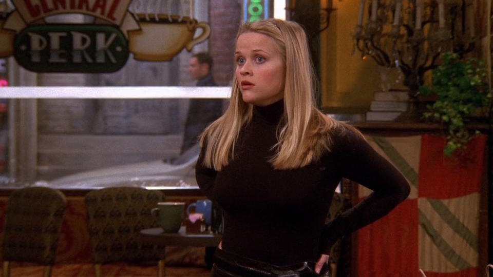 Reese Witherspoon wears a black sweater at the Central Perk in Friends