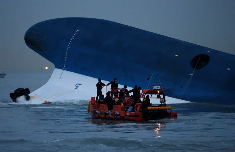 FILE PHOTO: Maritime police search for missing passengers near capsized South Korean ferry "Sewol" at the sea off Jindo