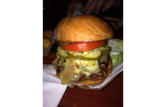 Blue Roof Bistro - Roasted Chili Steak Burger has a roasted chili sauce,flank  steak, beef patty, arugula, and melted Swiss in a potato bun served w/ a  side is the special of