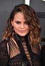 Model Chrissy Teigen looked smoking hot as she walked the red carpet with her short bob styled into perfect waves. She matched her wet-hair look with nude lipgloss, lashings of black eyeliner and heavy contouring.