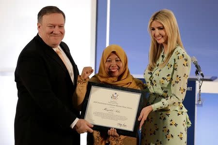 U.S. Secretary of State Mike Pompeo and White House senior advisor Ivanka Trump award Maizidah Salas, migrant worker from Indonesia, during an event to unveil the 2018 Trafficking in Persons (TIP) Report at the State Department in Washington, U.S., June 28, 2018. REUTERS/Yuri Gripas