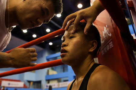 Huang Wensi sits in her corner during her fight against Thailand's Jarusiri Rongmuang for the Asia Female Continental Super Flyweight Championship gold belt in Taipei, Taiwan, September 26, 2018. REUTERS/Yue Wu