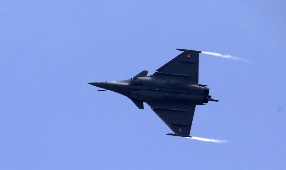 FILE - In this Thursday, Sept. 10, 2020, file photo, a French-made Rafale fighter jet flies during its induction ceremony at the Indian Air Force Station in Ambala, India. Greece's government says on Thursday, Dec. 17, 2020, it will pay 2.32 billion euros ($2.8 billion) for the purchase of French-made Rafale fighter jets and an upgrade of compatible air-to-air missile systems and part of a major military overhaul. (AP Photo/Manish Swarup, File)