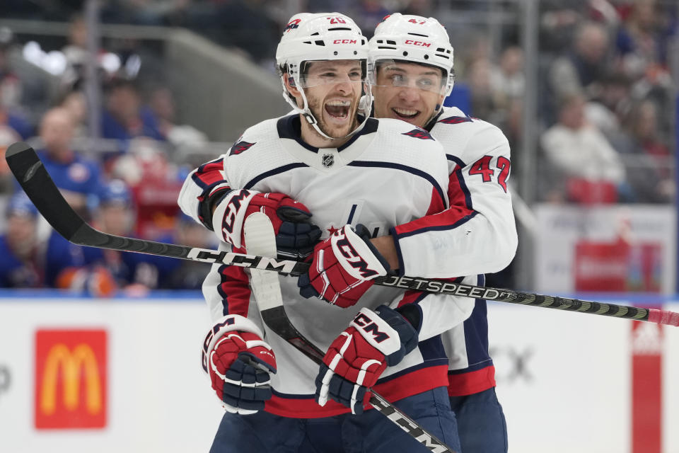 Washington Capitals center Nic Dowd (26) celebrates with defenseman Martin Fehervary (42) after scoring against the New York Islanders during the third period of an NHL hockey game Saturday, March 11, 2023, in Elmont, N.Y. (AP Photo/Mary Altaffer)