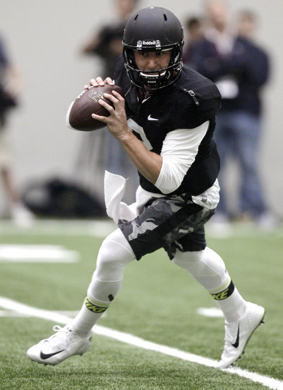 Texas A&M quarterback Johnny Manziel passes the ball during a drill at pro day for NFL football representatives in College Station, Texas, Thursday, March 27, 2014. (AP Photo/Patric Schneider)