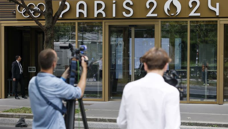 Reporters work outside the headquarters of the Paris Olympic organizers, Tuesday, June 20, 2023 in Saint-Denis, outside Paris. French investigators searched the headquarters of Paris Olympic organizers on Tuesday in a probe into suspected corruption, according to the national financial prosecutor’s office.