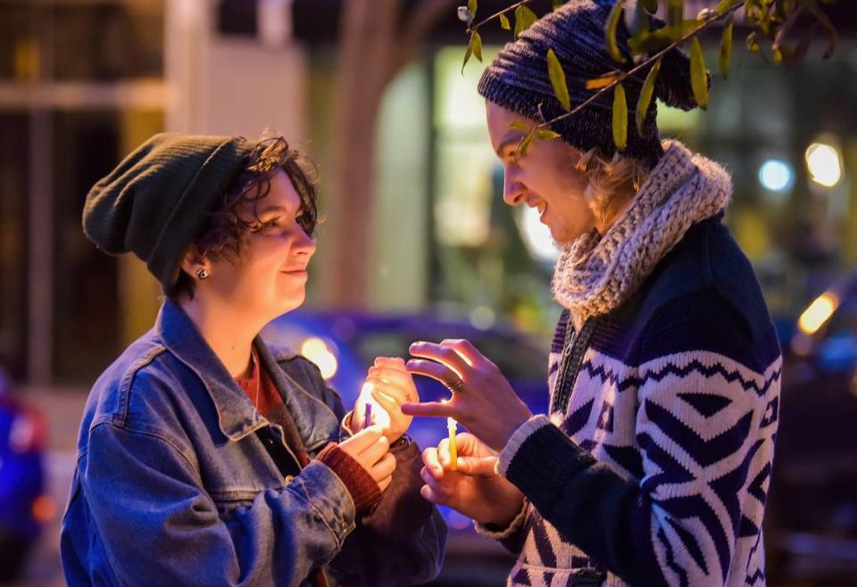 Felix Deleon and Henry Craig attend a lighting ceremony Nov. 28, 2021, for a public, 12-foot Hanukkah menorah at 11th Street and Broadway in downtown Columbus.